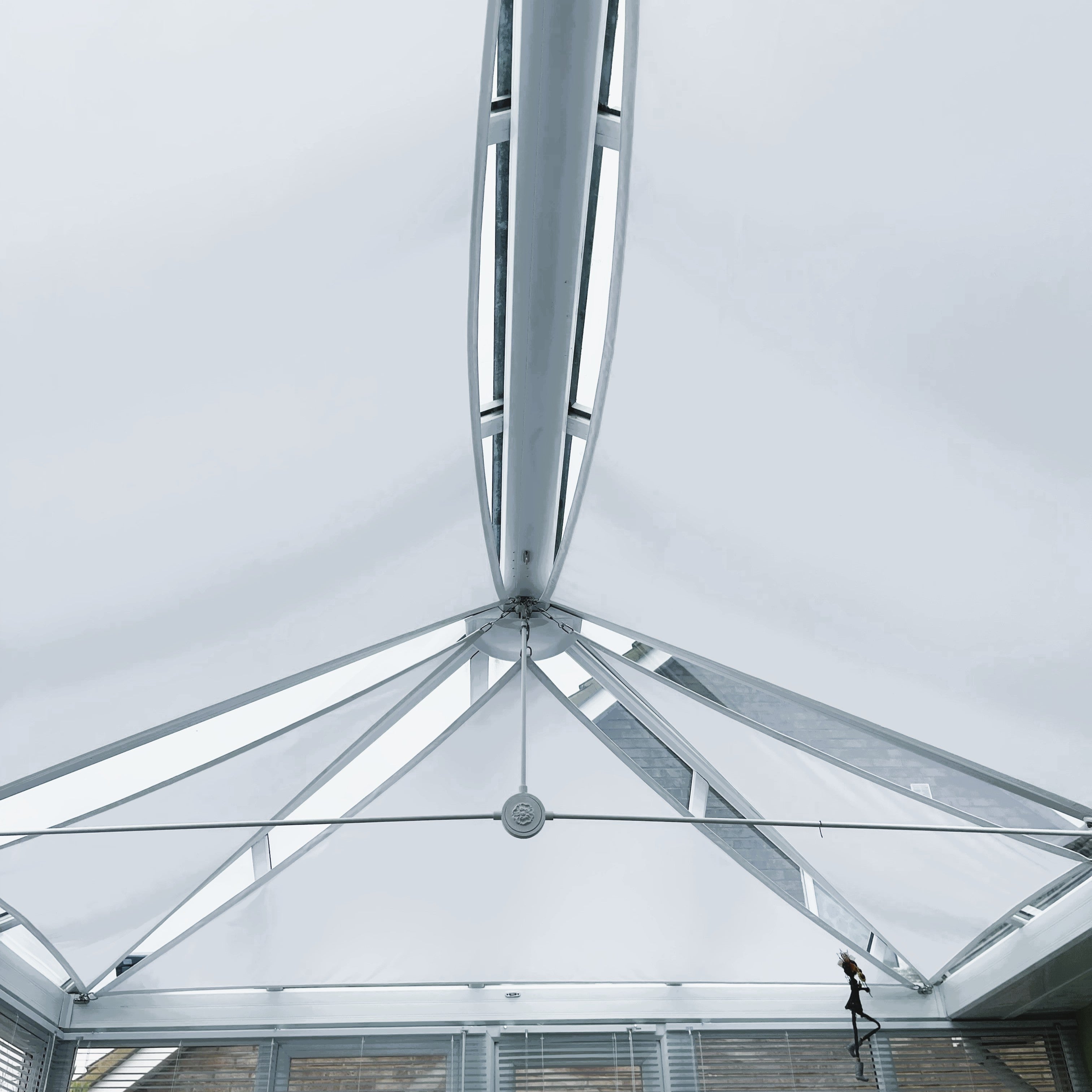 Modern conservatory with shade sail in the roofline for sun protection